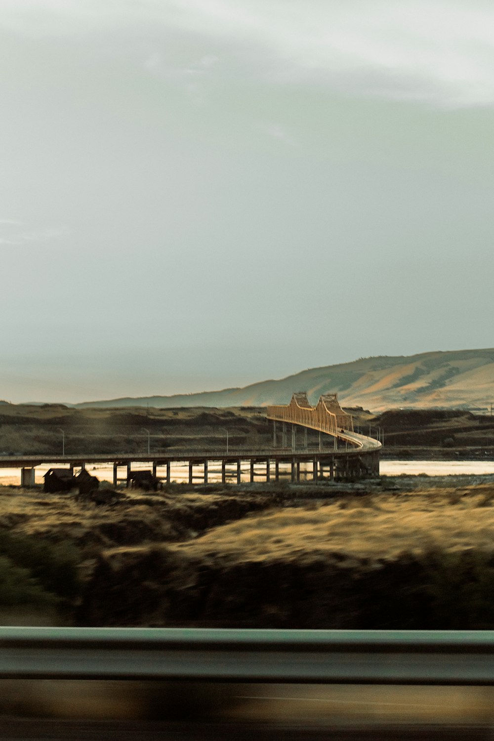 a bridge over a body of water in the middle of nowhere