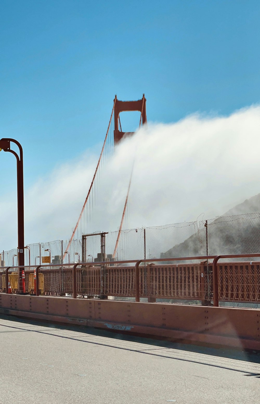 a man riding a bike across a bridge