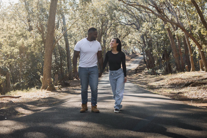 couple walking down a tree-lined road