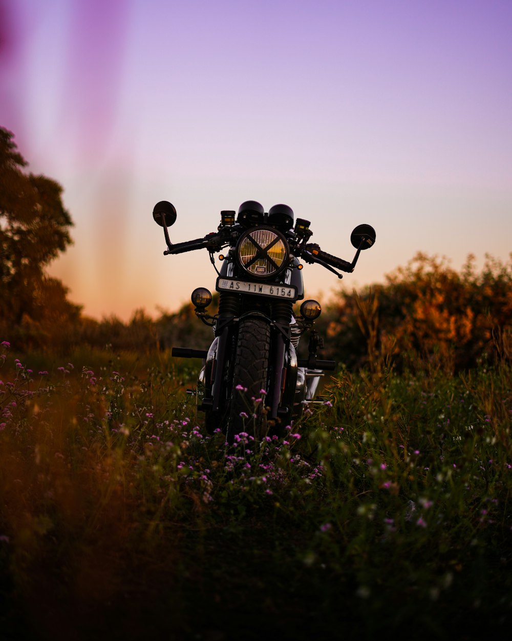 a motorcycle parked in the middle of a field