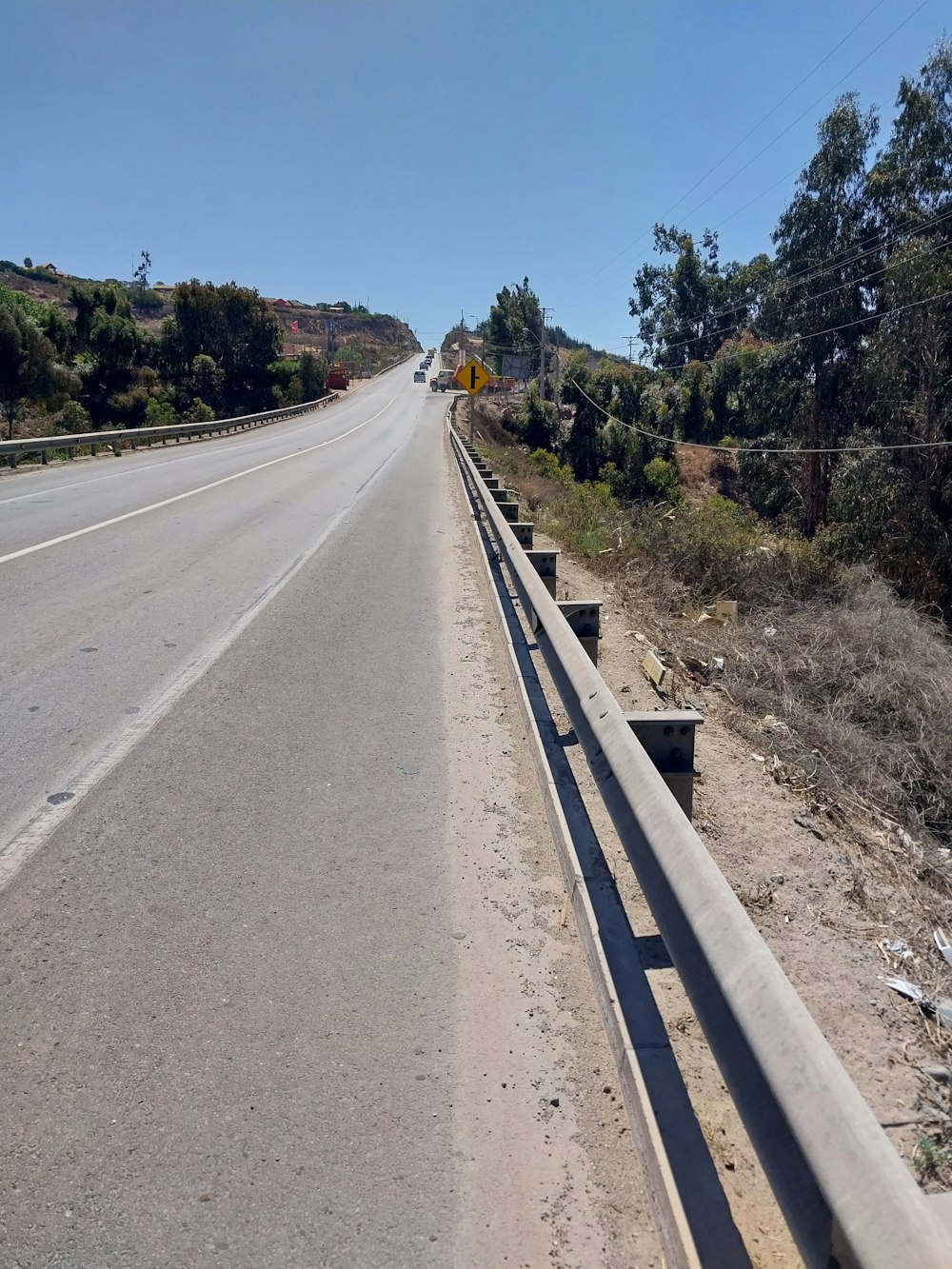 a highway with a guard rail on the side of it