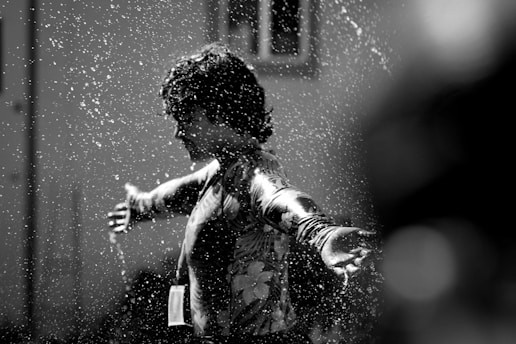 a little boy that is standing in the water