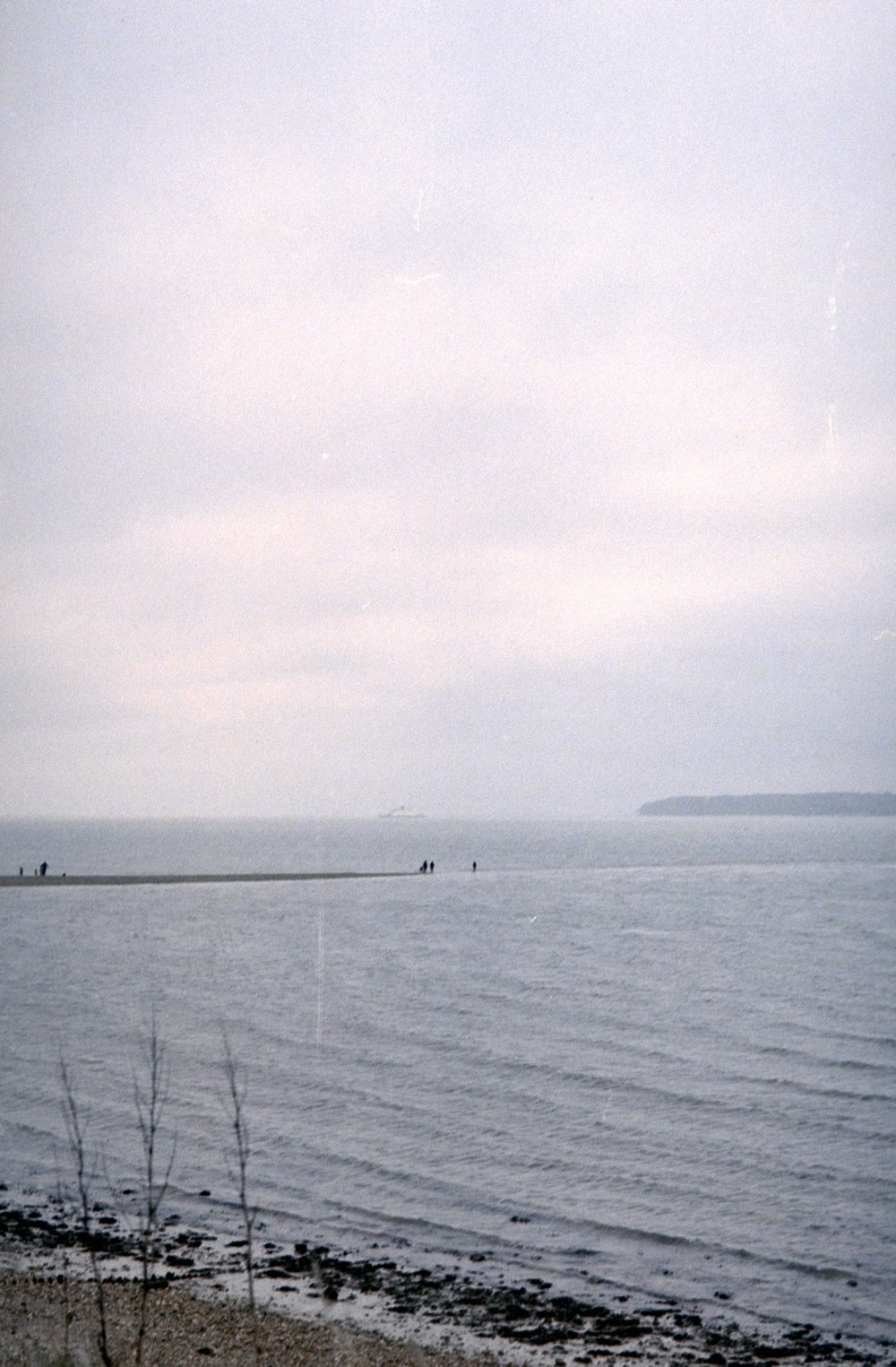 a large body of water sitting under a cloudy sky
