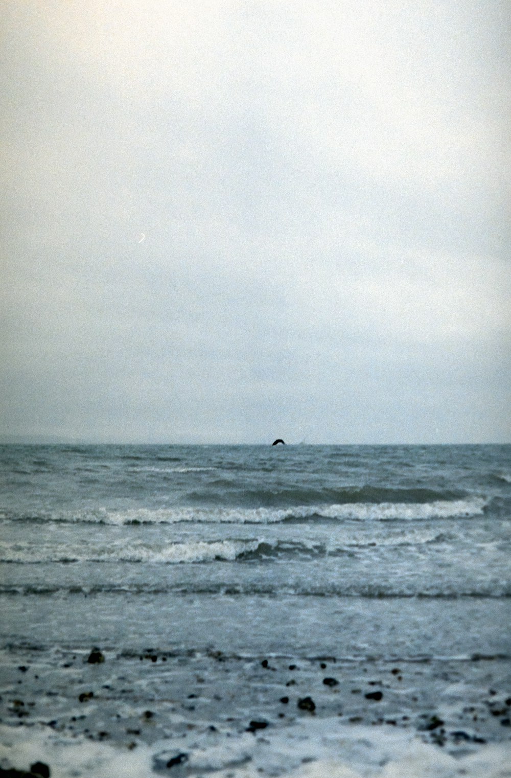 a person riding a surfboard on top of a wave in the ocean