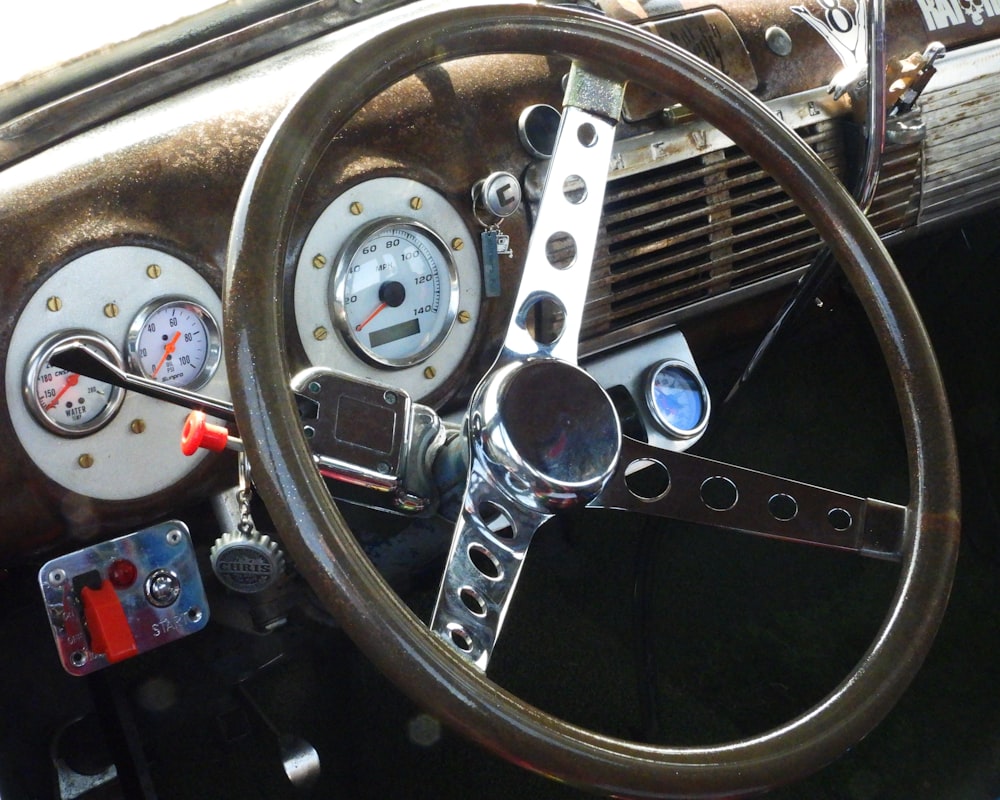 a steering wheel and dashboard of an old car