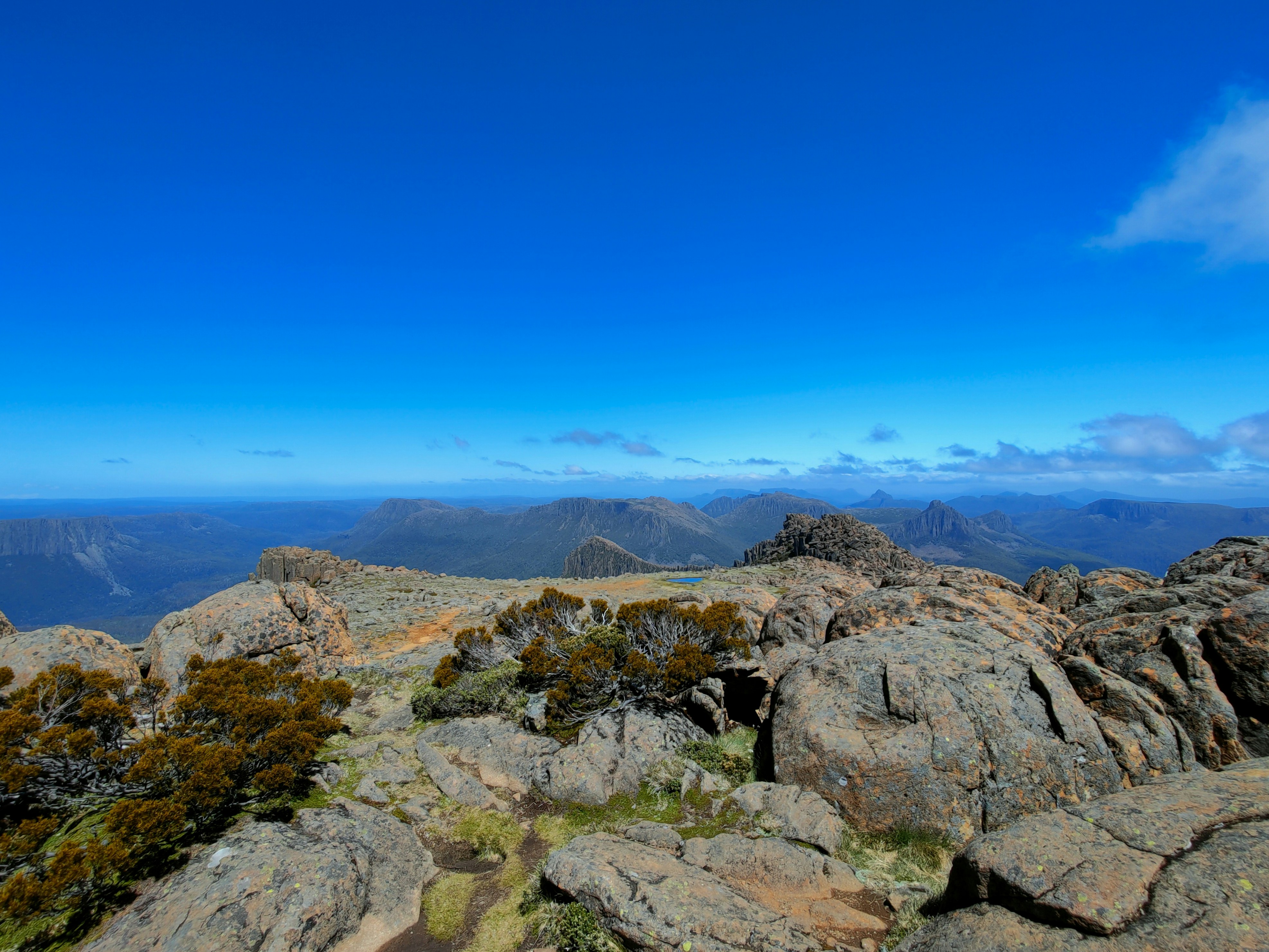 a view of the mountains from a rocky outcropping