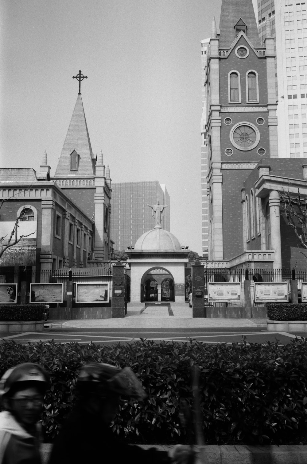 a black and white photo of a church and a motorcycle