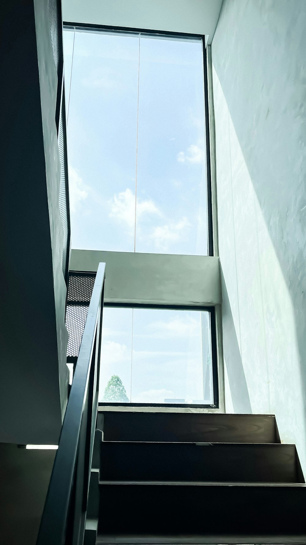 a staircase leading up to a skylight window