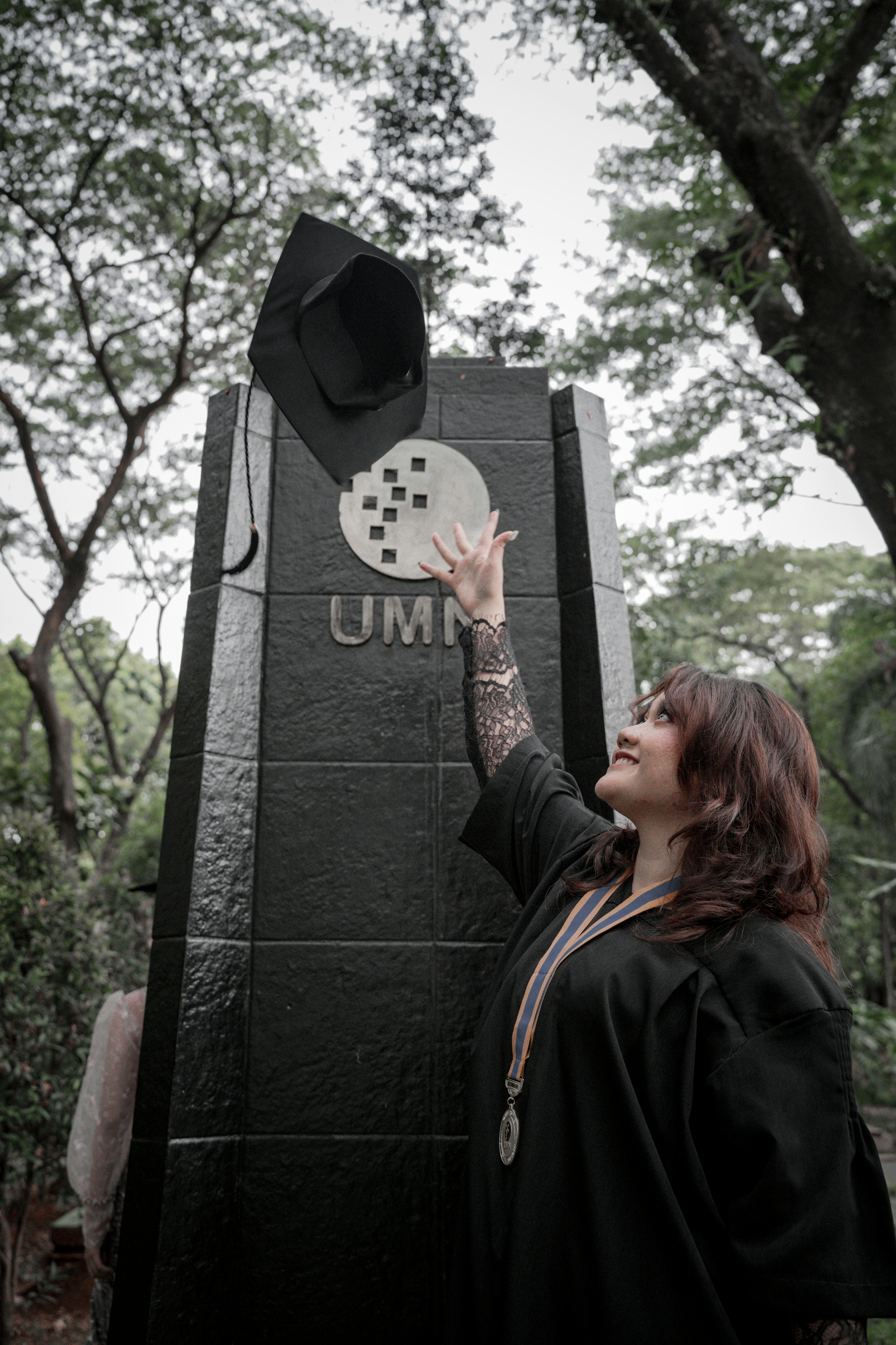 a woman touching a hat on top of a monument