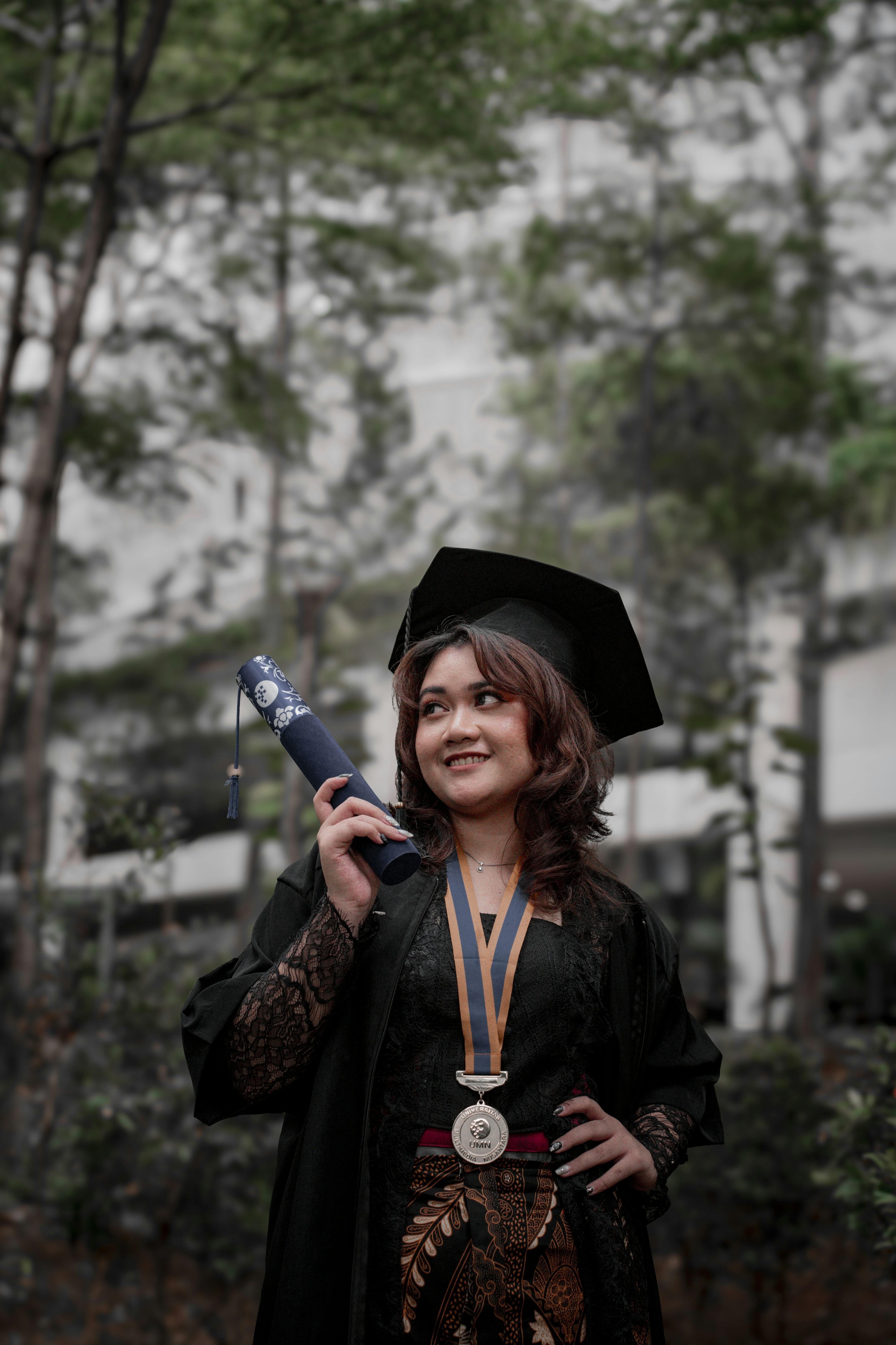 a woman in a graduation gown holding a diploma