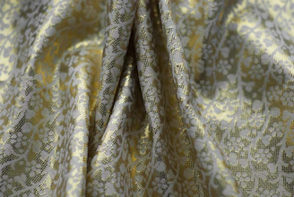 a close up of a yellow and white fabric