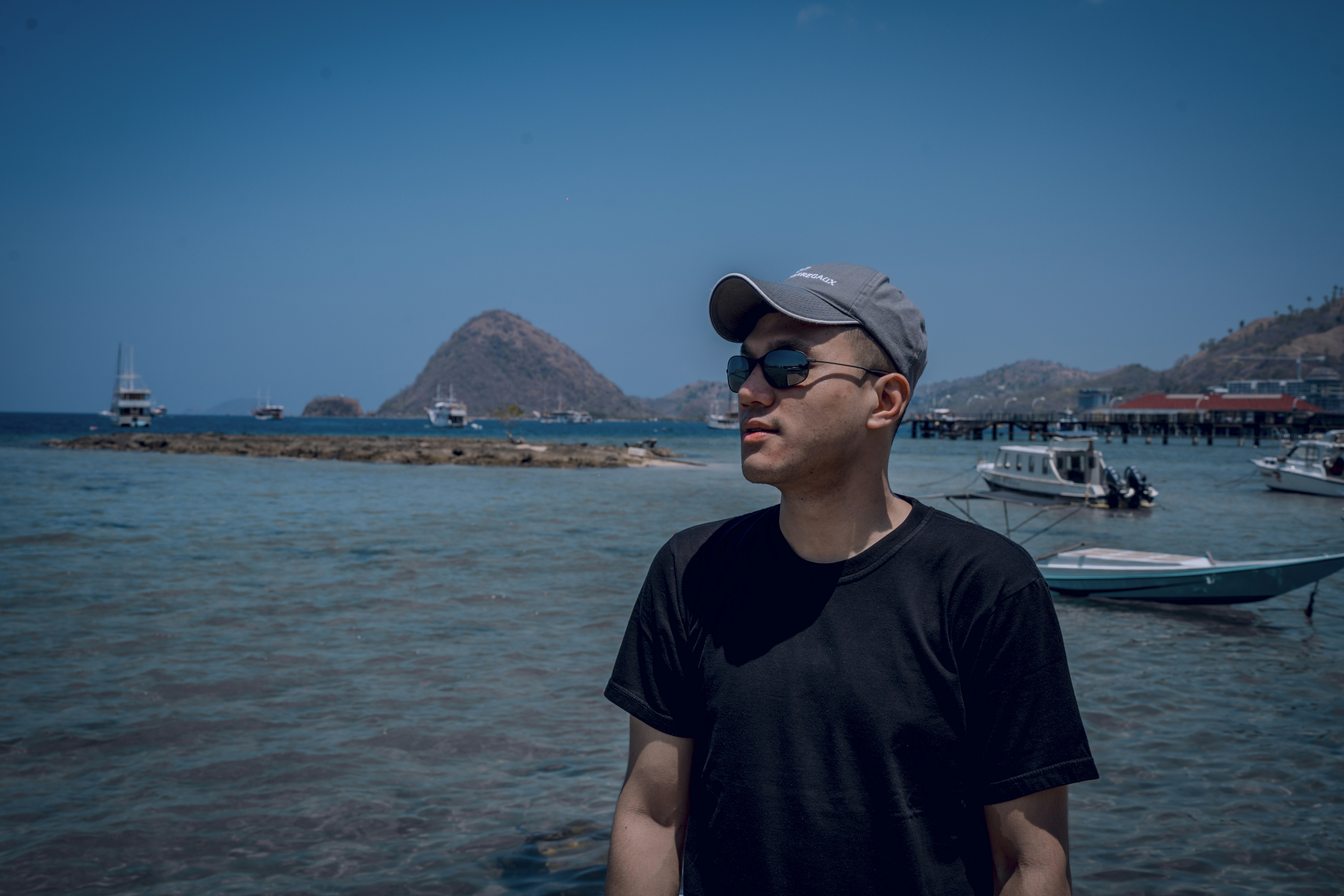 a man standing in front of a body of water