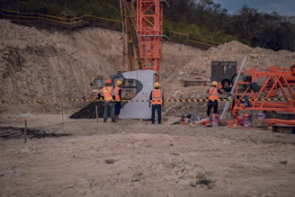 a group of men standing around a construction site