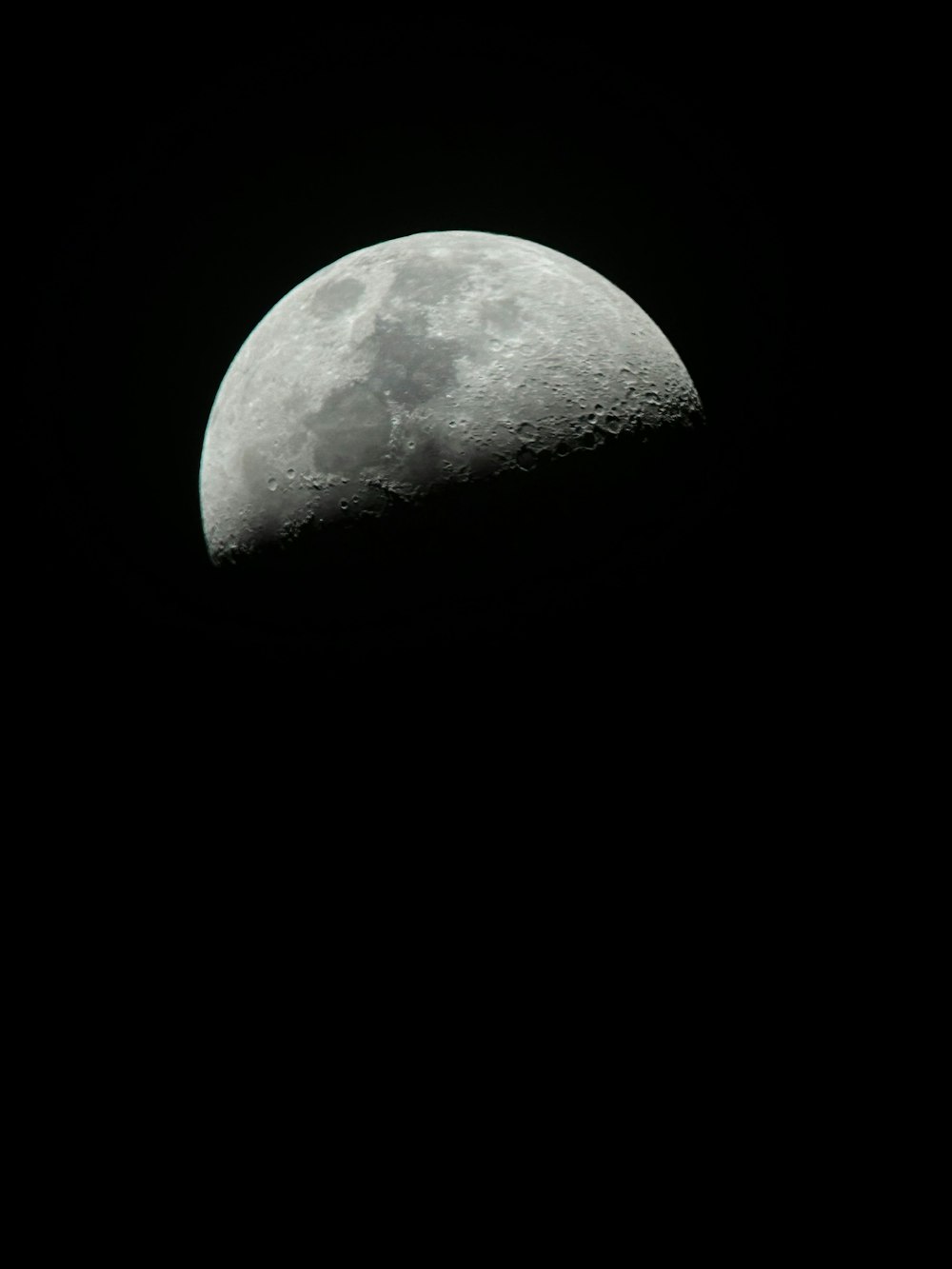 a close up of a half moon in the sky