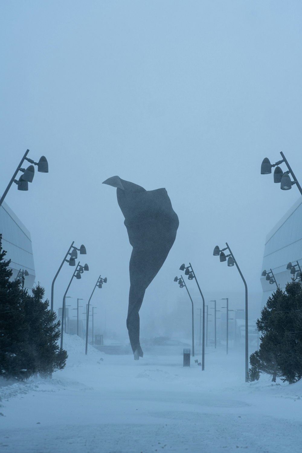 a person standing in the middle of a snowy street