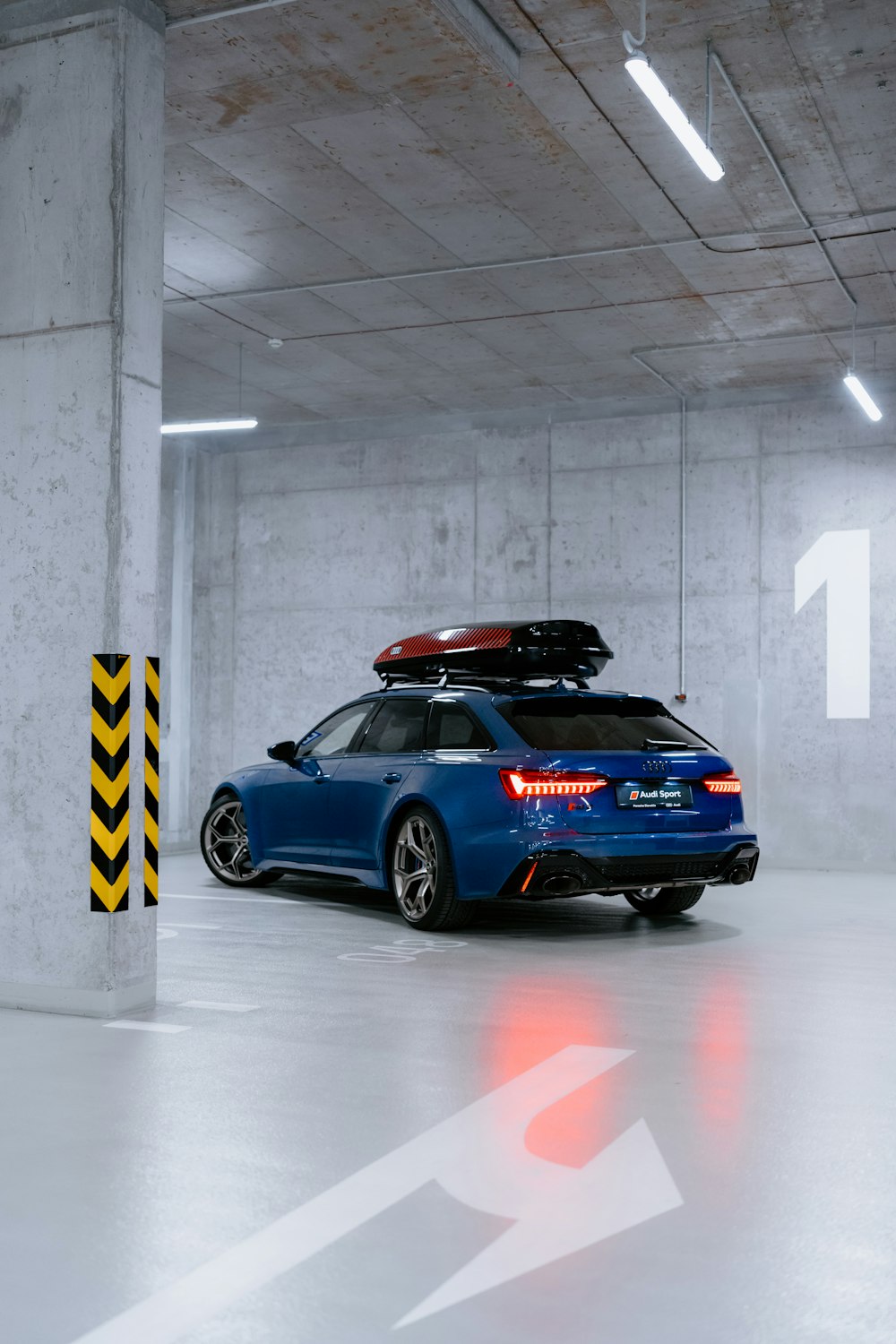 a blue car parked in a parking garage