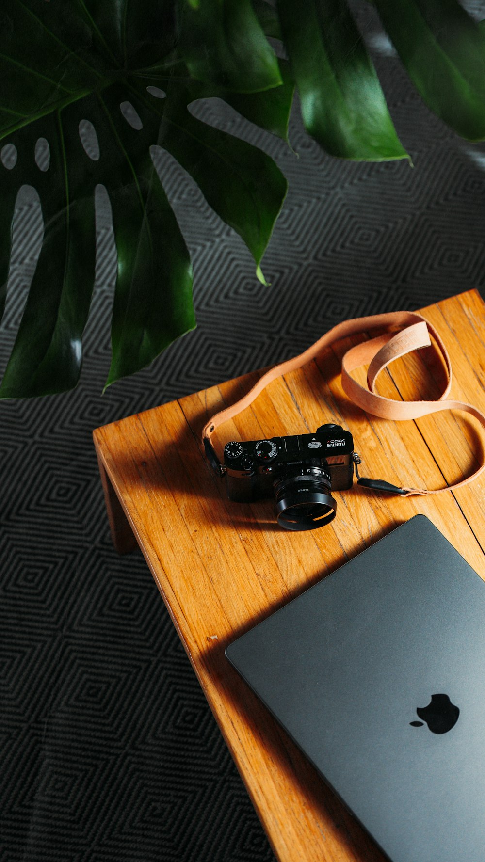 a wooden table topped with a laptop computer