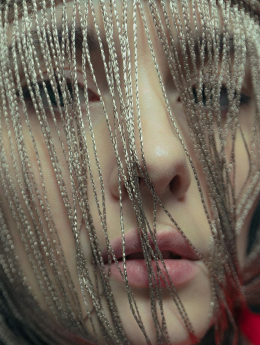 a close up of a person with chains on their face