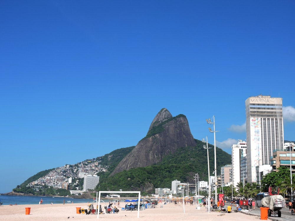 a beach with a volleyball goal and a mountain in the background