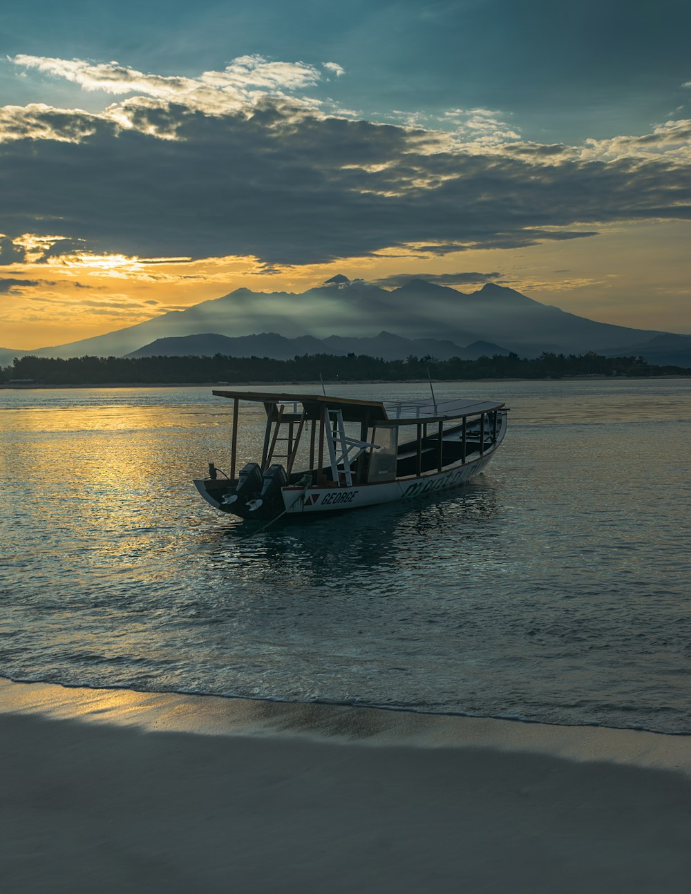 a small boat floating on top of a body of water