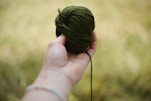 a person holding a ball of yarn in their hand