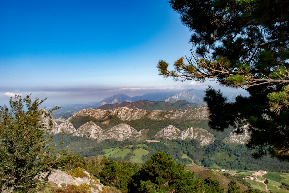 a view of a mountain range from the top of a hill