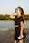 a woman standing next to a body of water