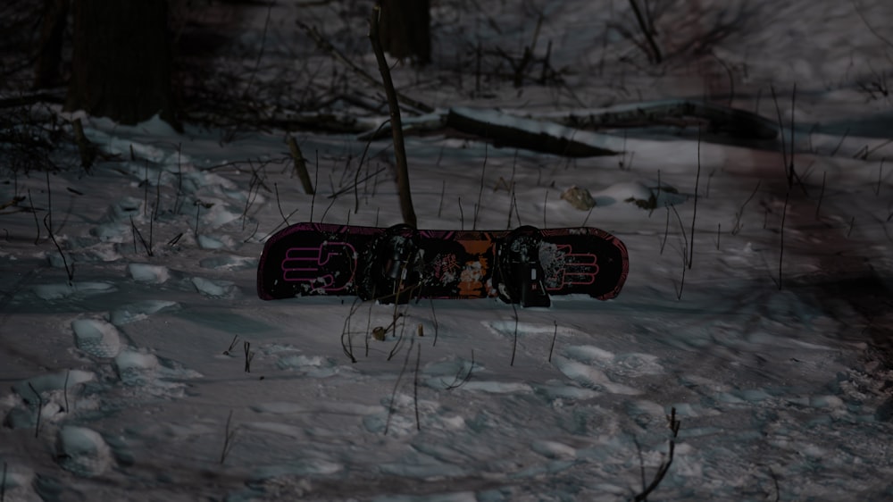 a snowboard laying on the ground in the snow