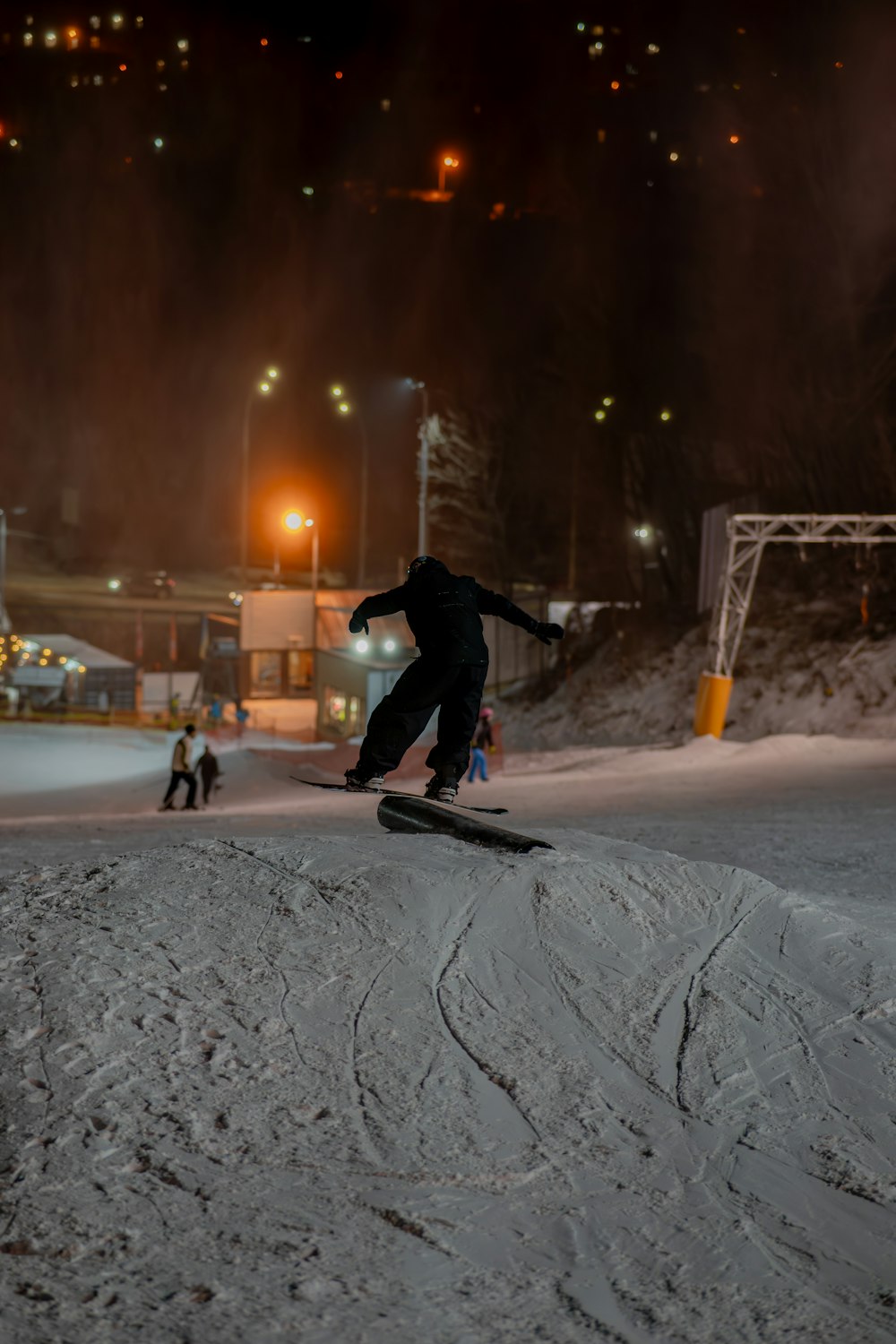 a man riding a snowboard down the side of a snow covered slope