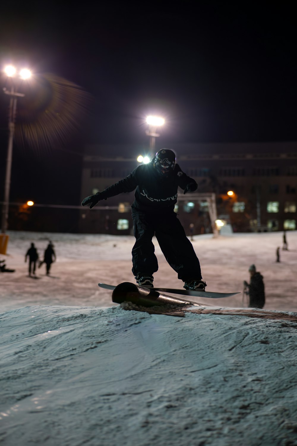 a man riding a snowboard down the side of a snow covered slope