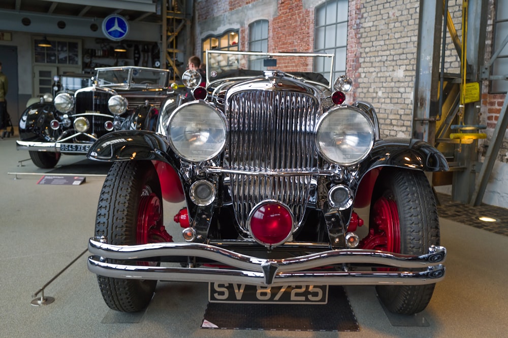 a vintage car is on display in a museum