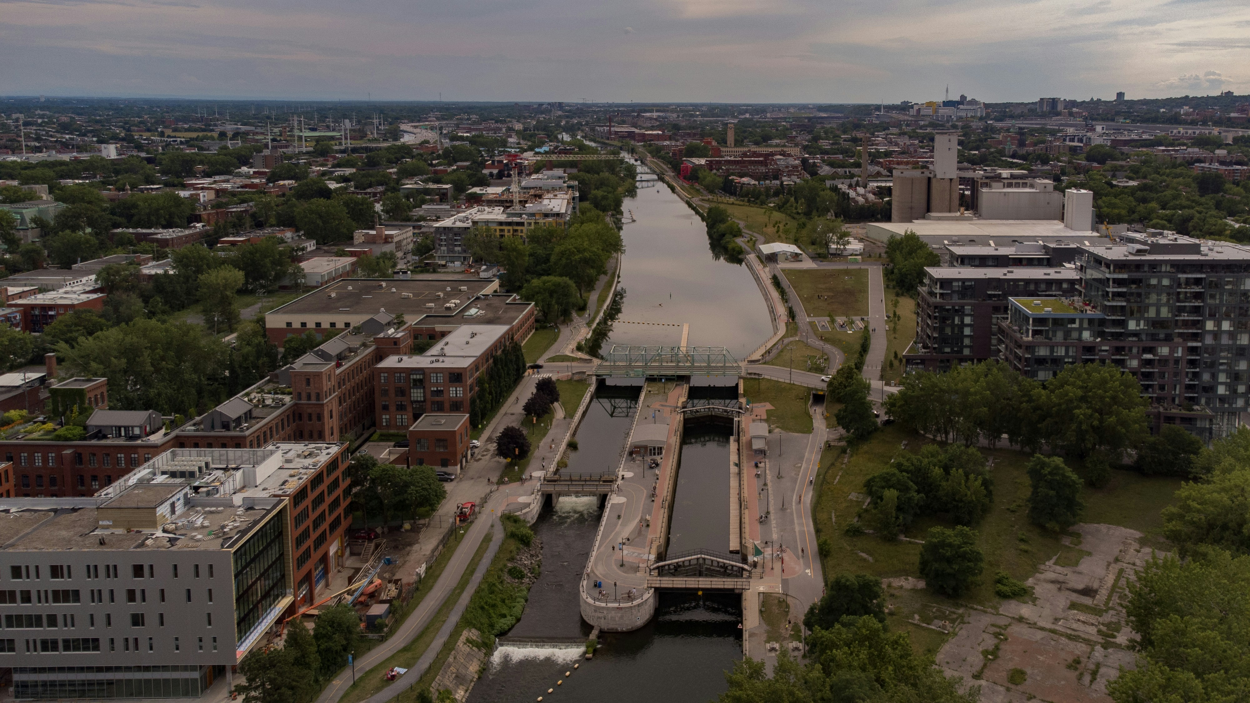 an aerial view of a river running through a city, 