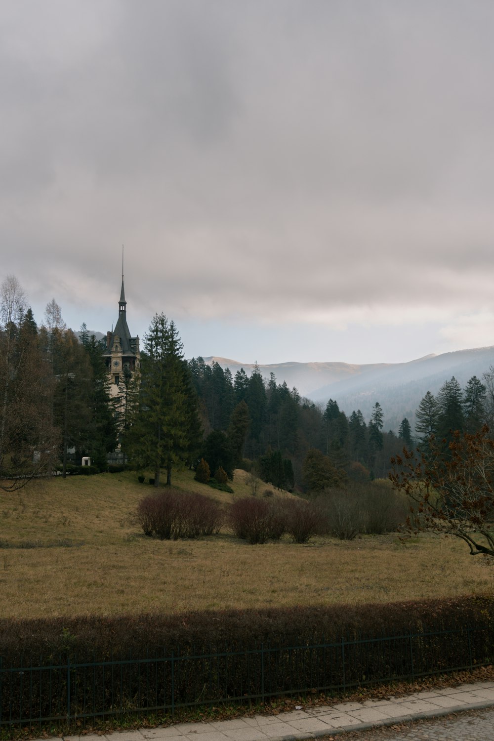 a large field with a church in the background