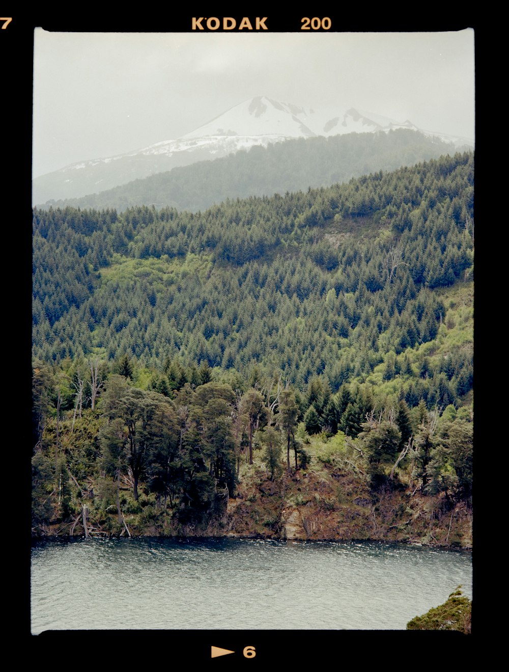 a picture of a mountain with a lake in front of it