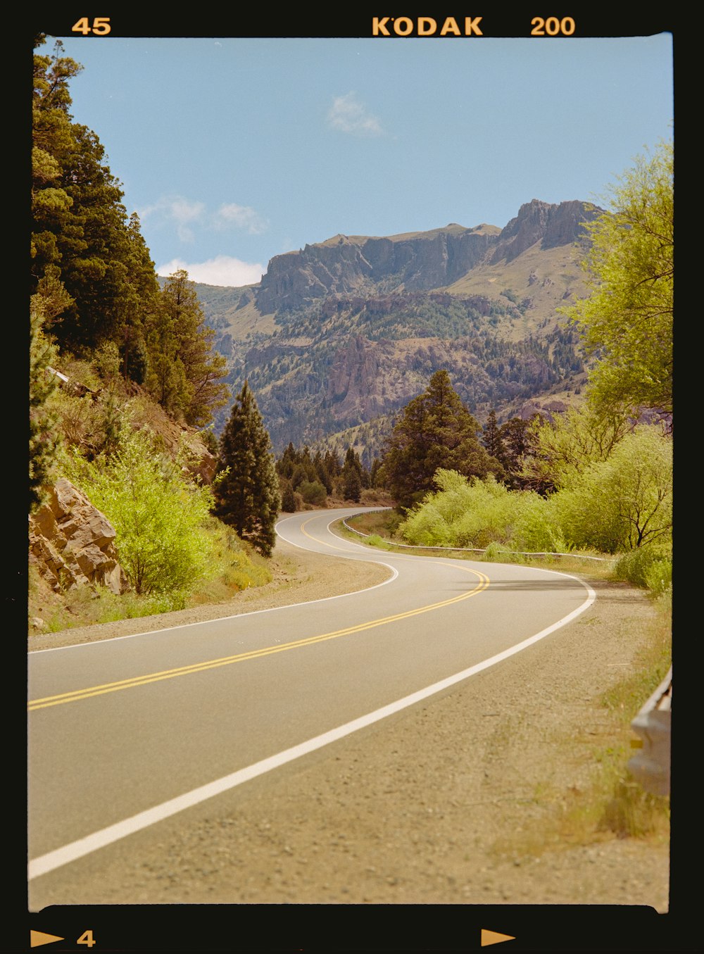 a picture of a road with mountains in the background