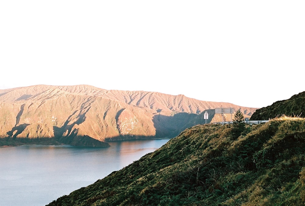 a scenic view of a body of water with mountains in the background