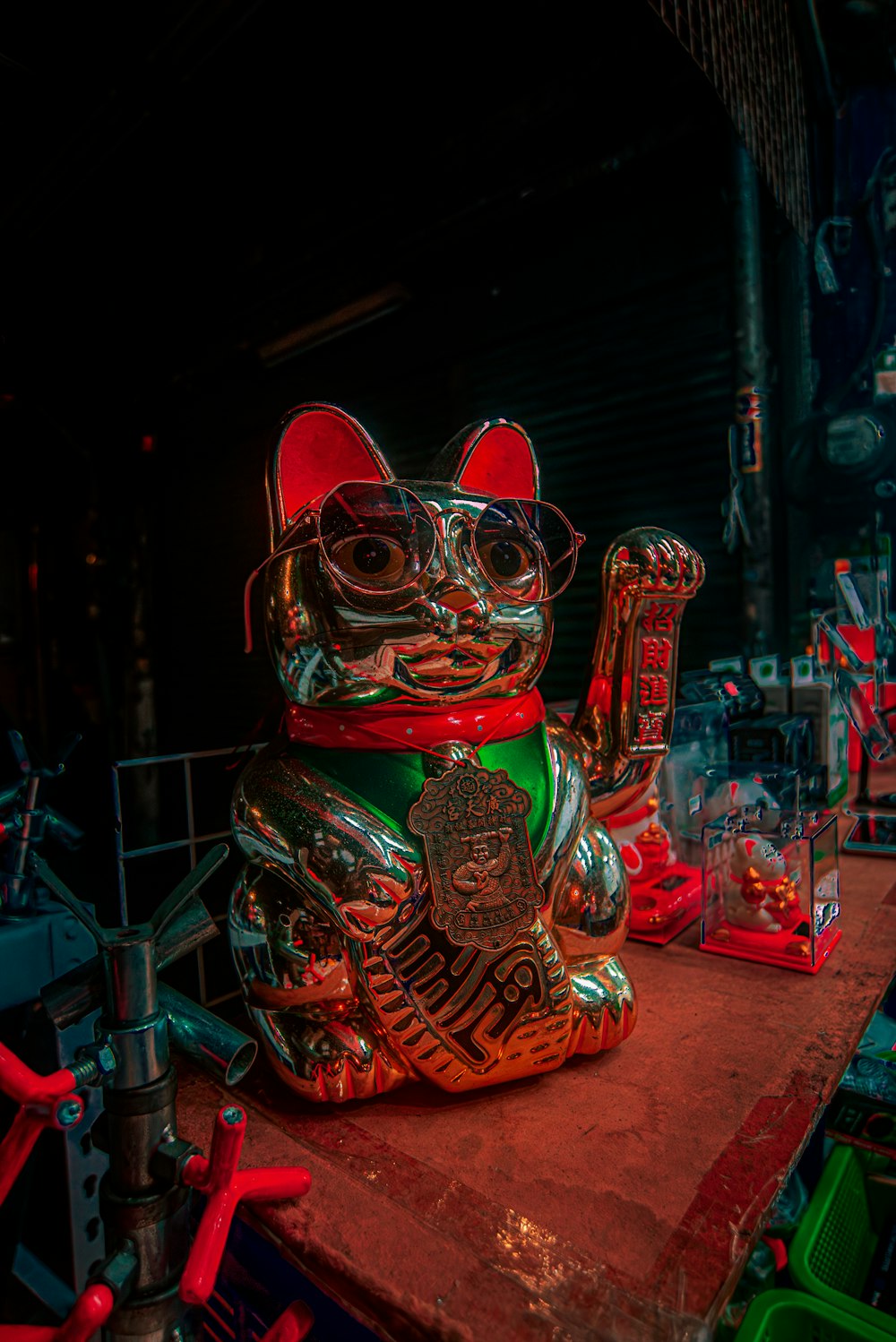 a statue of a cat with glasses on top of a table