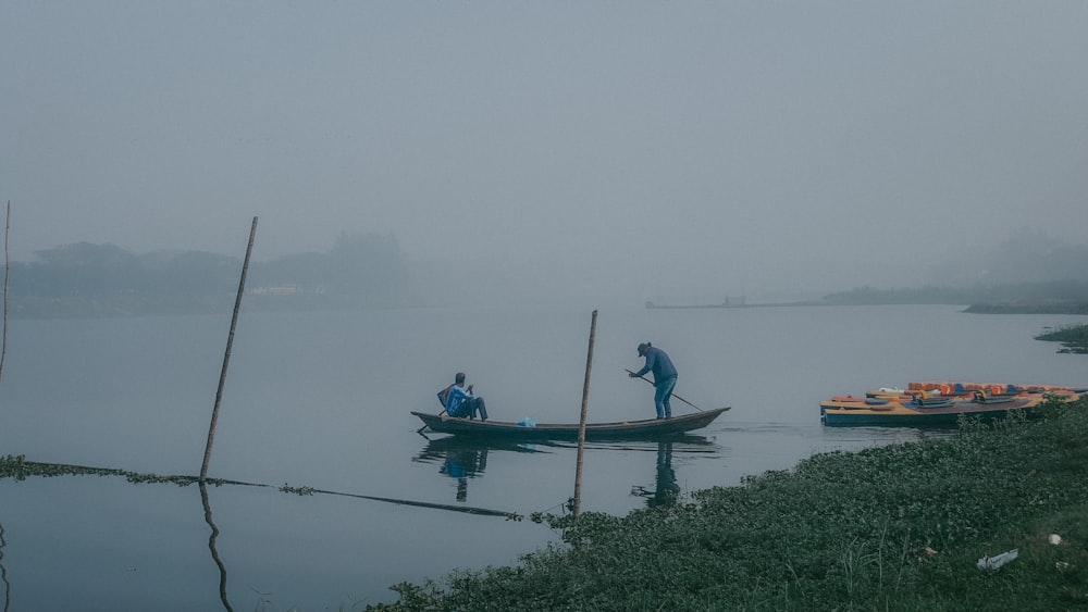 a couple of people in a boat on a body of water