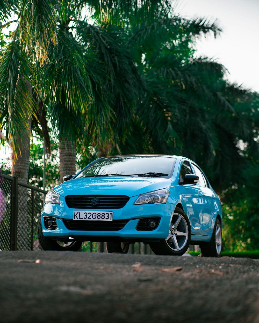 a blue car parked on the side of the road