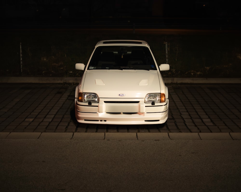 a white car parked on the side of the road