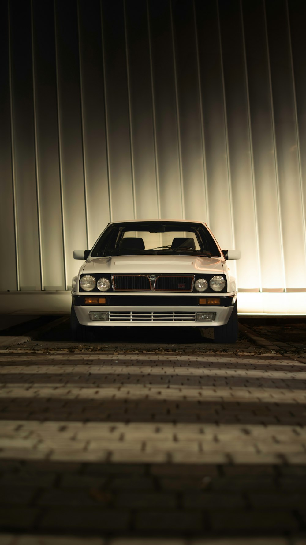 a white car parked in front of a building