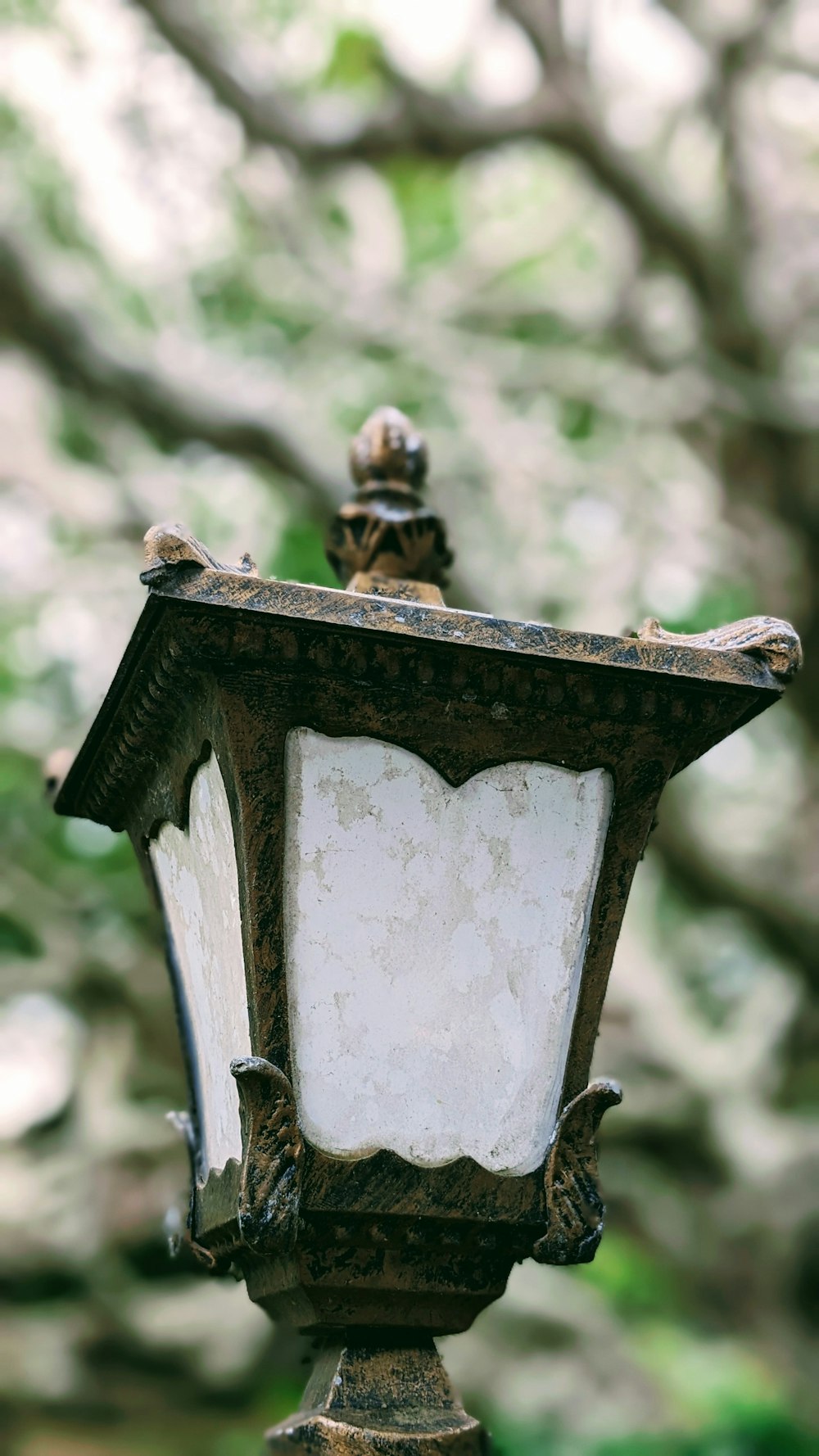 a lamp post with a statue on top of it