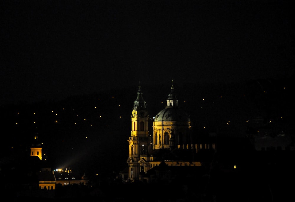 a large building with a clock tower at night