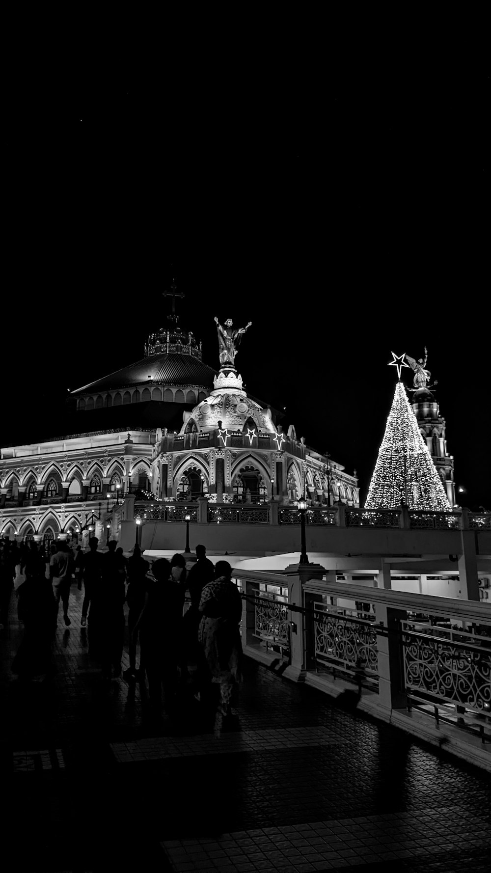 a black and white photo of people standing in front of a building