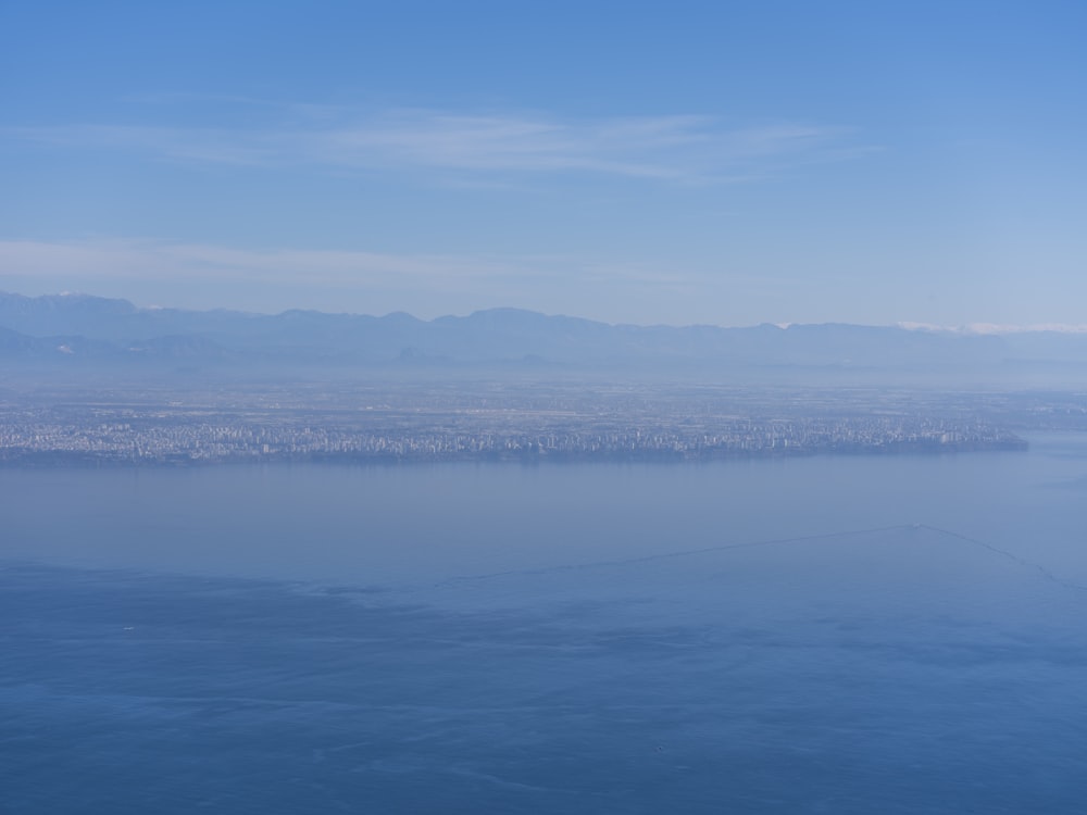 a view of a body of water with mountains in the background