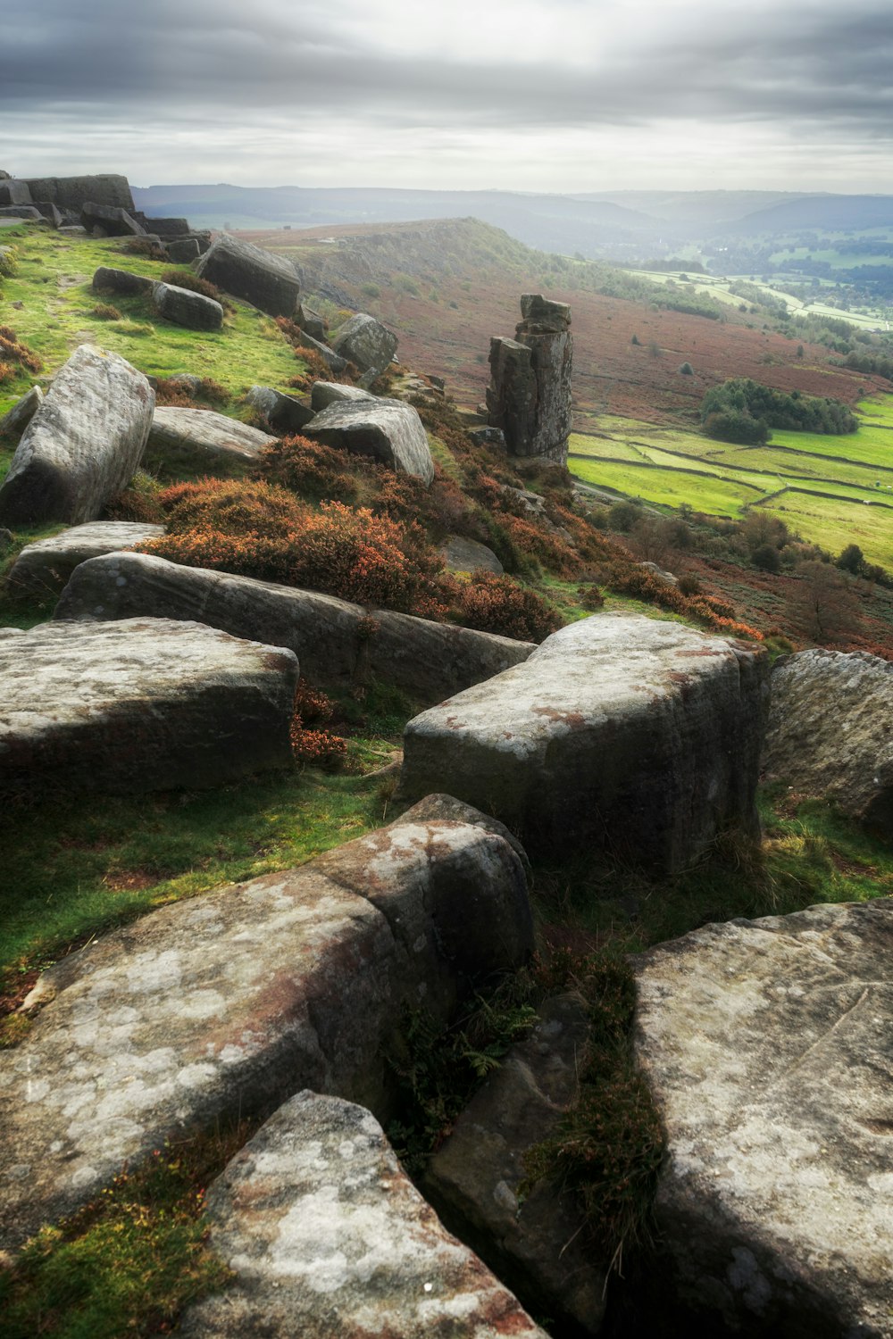 a rocky hillside with grass and rocks on it