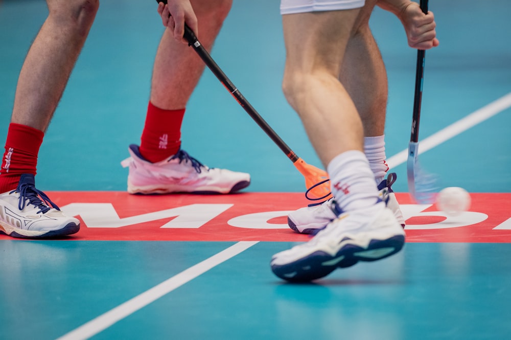 a group of people playing a game of field hockey