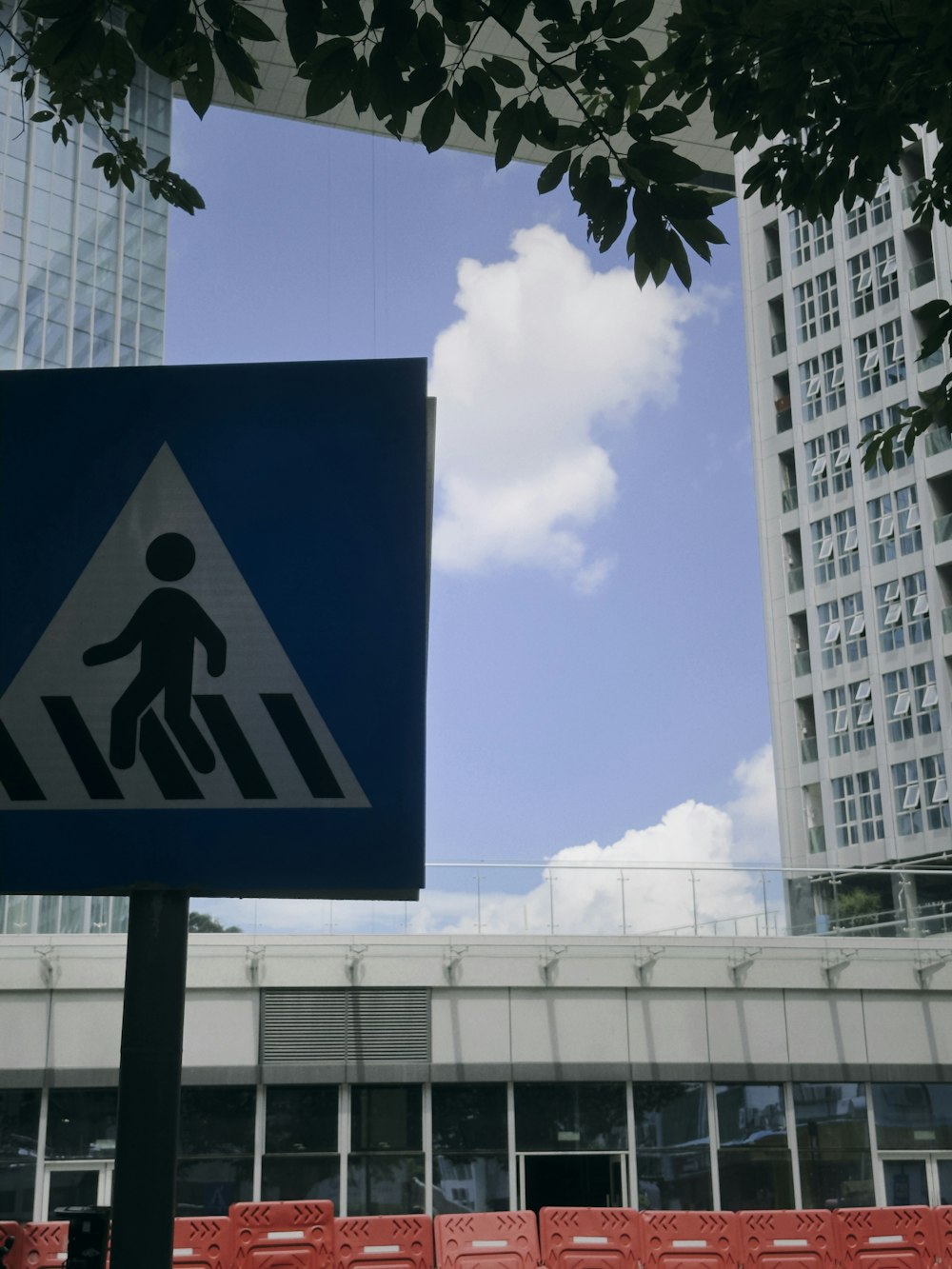 a pedestrian crossing sign in front of a building