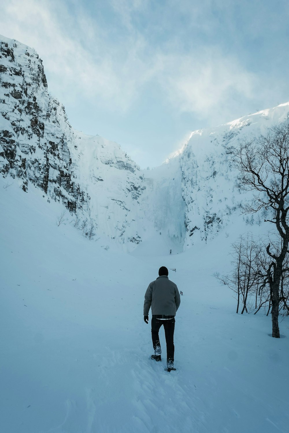 a man riding a snowboard down a snow covered slope