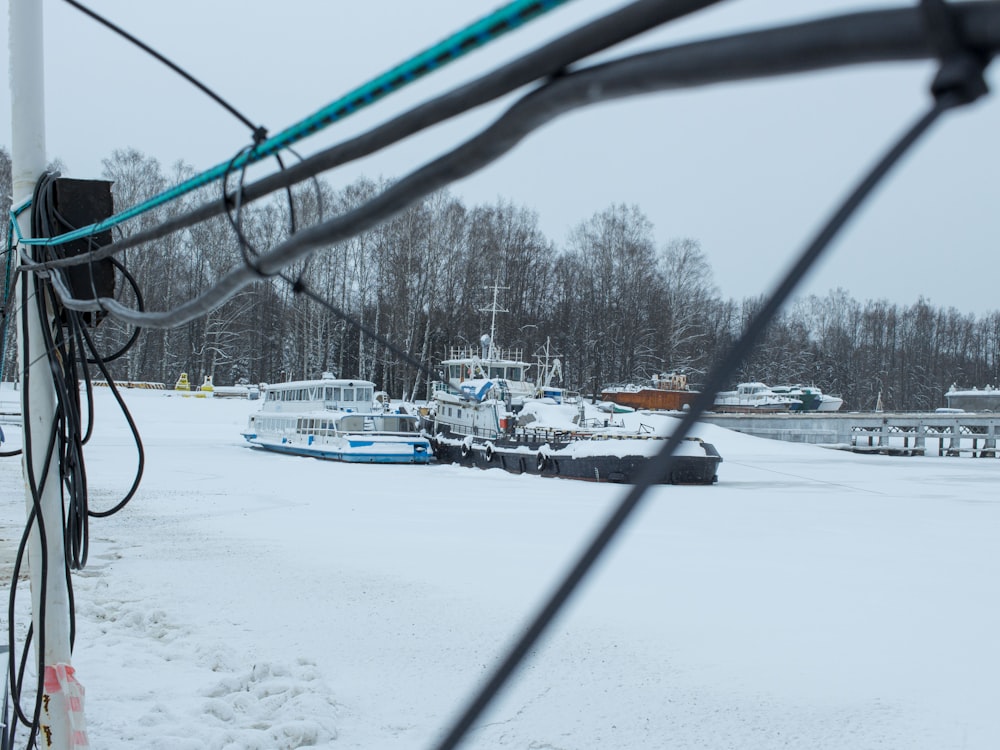 a couple of boats that are sitting in the snow